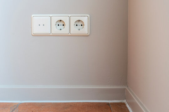 3-fold European wall socket assembly with one cover and two Schuko power outlets