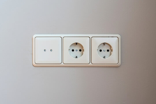 3-fold European wall socket assembly with one cover and two Schuko power outlets