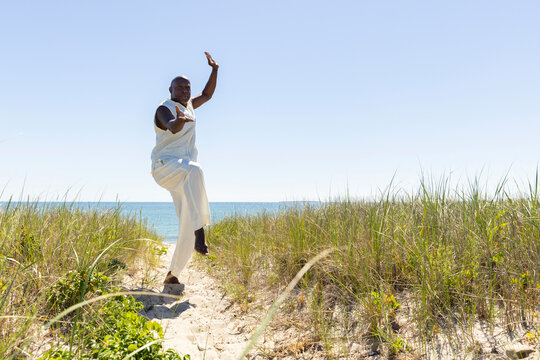 Black man self care  doing Tai Chi on Beach 