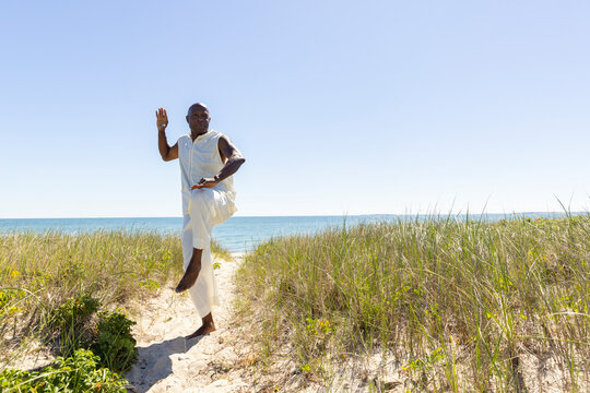 Black man balance  doing Tai Chi on Beach 