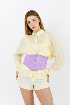 Woman modeling lilac corset and pastel outfit