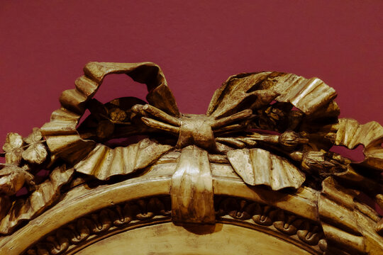 Decorative Gold Frame With Bow Design on a Wall