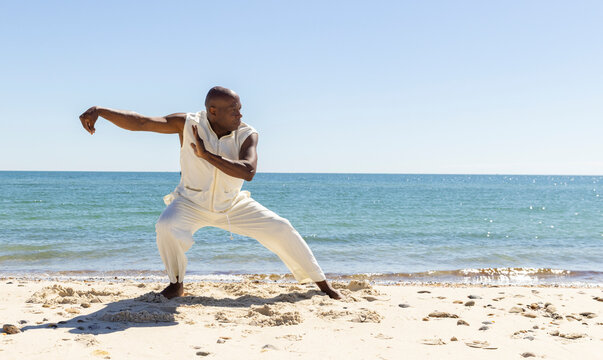Landscape Black man doing Tai Chi on Beach 
