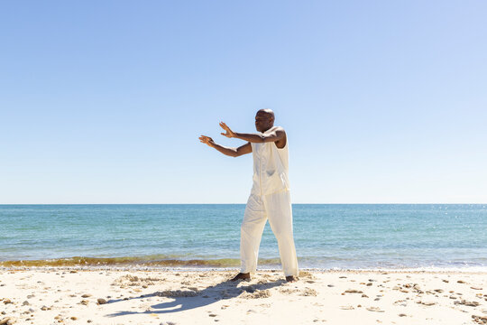 Lone Black man doing Tai Chi on Beach 