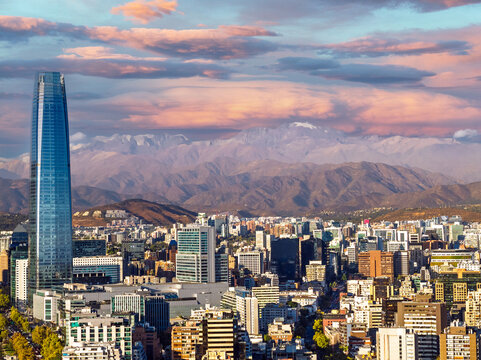 Aerial view of Santiago city skyline with skyscraper and Andes mountains in the background at sunset