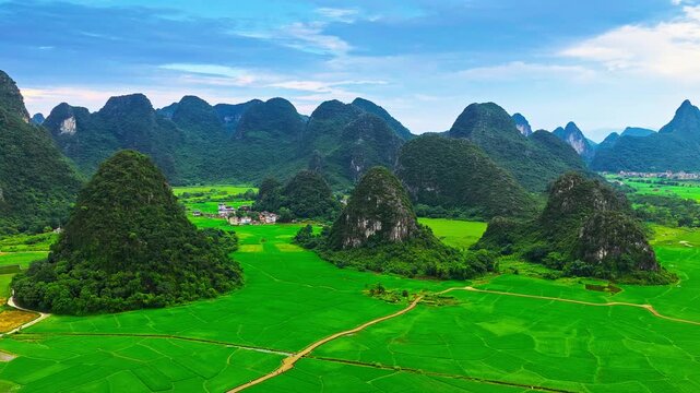 Aerial view of karst mountain hills and lush green rice paddy fields in Guilin, Guangxi, China.
