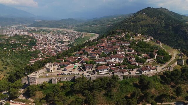 Aerial Drone View of Berat Albania Showing the Historic Mangalem District, Berat Castle and Surrounding Green Hills in the Balkan Mountains