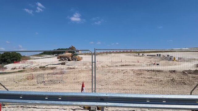 Winchester Hampshire England UK. 16.07.2026. Video. M3 and A34 interchange, expansive view of a busy construction site with heavy equipment and materials