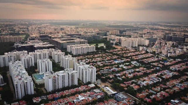 Aerial drone view of rapidly expanding residential and commercial real estate in Bangalore, Karnataka, India, featuring modern apartment complexes, construction projects, and the city's fast-growing u