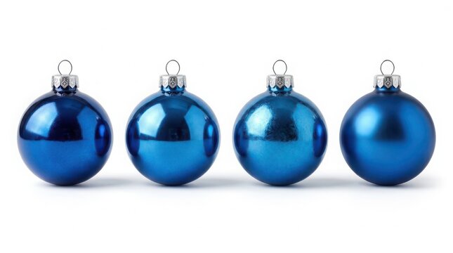 Four shiny blue christmas bauble ornaments arranged in a row for holiday season decoration and festive tree celebration