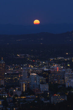 Full Moon Rising Above Portland Oregon Skyline and Cascade Bridge at Dusk, Vertical Editorial
