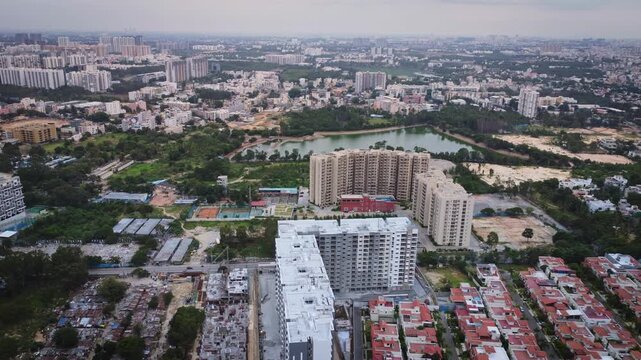 Aerial drone view of rapidly expanding residential and commercial real estate in Bangalore, Karnataka, India, featuring modern apartment complexes, construction projects, and the city's fast-growing u