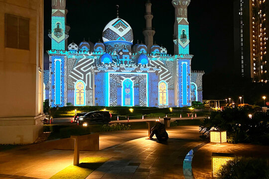 Beautiful Masjid At Thohir Mosque Illuminated with Colorful Lights at Night, Showcasing Stunning Islamic Architecture, Glowing Domes, Elegant Minarets, and a Peaceful Spiritual Atmosphere in Indonesia