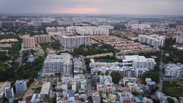 Aerial drone view of rapidly expanding residential and commercial real estate in Bangalore, Karnataka, India, featuring modern apartment complexes, construction projects, and the city's fast-growing u