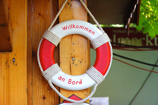 Nautical decorative lifebuoy ring with welcome on board text on wooden background⁠