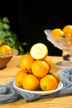 Fresh Kumquats and Citrus Fruits on Rustic Wooden Table with Natural Kitchen Styling