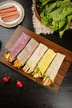 Colorful Vegetable and Meat Wrap Rolls on Wooden Board - Healthy Breakfast Lunch Option