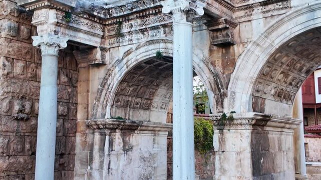 Detailed view of ancient stone arches and marble columns at historic hadrian's gate antalya.