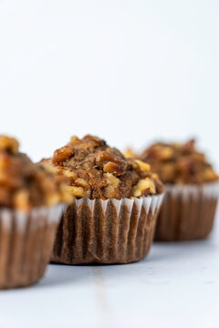 Banana muffins in paper liners sprinkled with walnuts 