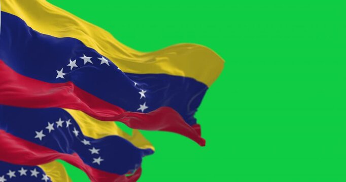 Close-up of Venezuela national flags waving isolated on green background