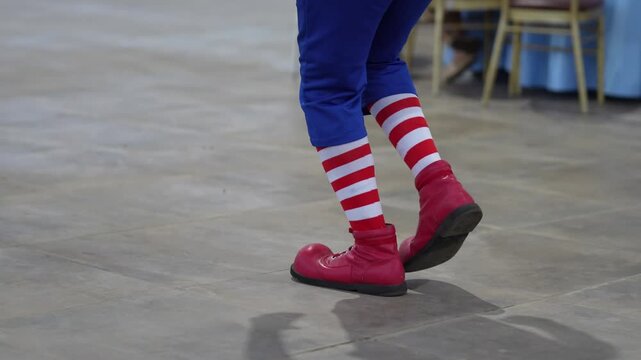 Clown feet walking, taking small steps.