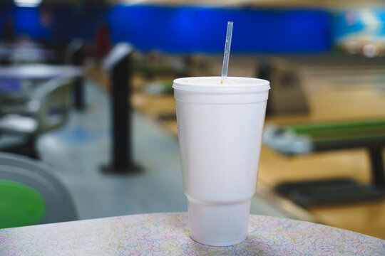 Styrofoam cup on a bowling alley table