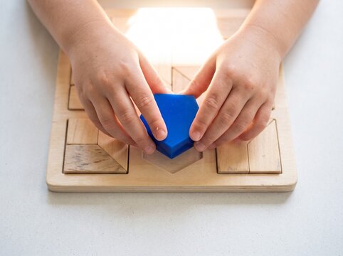 Child's hands fitting a blue geometric block into a wooden puzzle board for early educational development and learning skills