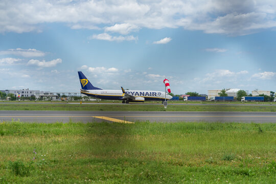 Ryan Air commercial passenger airplane taxiing on the asphalt tarmac and takeoff at an airport runway in Romania
