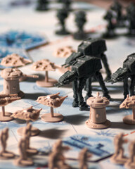 Fototapeta premium AT AT walkers advancing against Rebel forces during the Battle of Hoth on a detailed tabletop battlefield with defensive towers