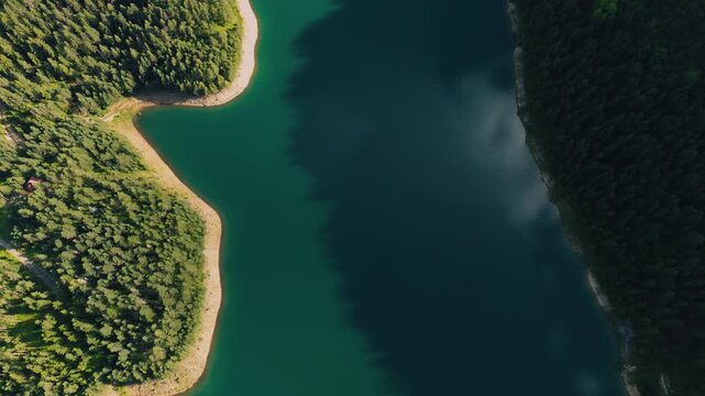 Birds eye view aerial of pristine mountain lake shore, top-down drone shot moving forward, Zaovina Lake in Serbia
