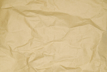 Fototapeta premium crumpled brown kraft paper with expressive texture wrinkles and folds across surface