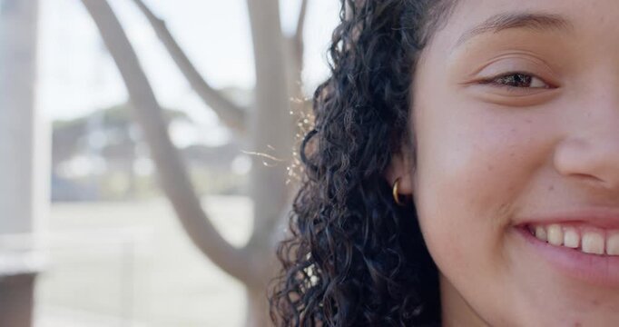 African American teen reacting to offscreen joke smiling and laughing showing gold hoop, copy space