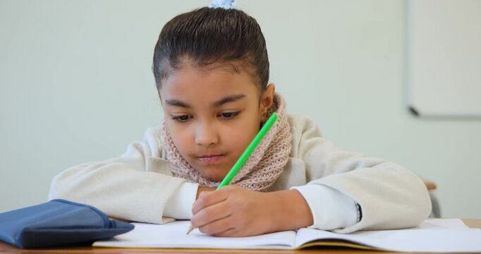 Youth female student doing worksheet at school swapping green pencil for pink via blue case writing