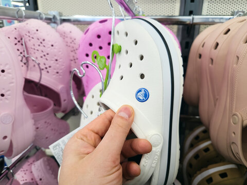Tyumen, Russia-March 20, 2026: Display of Crocs shoes in a retail store with various colors and styles available
