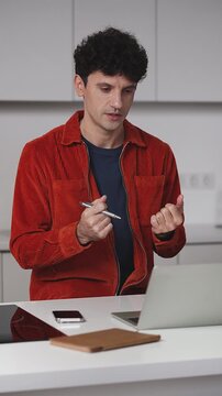 Young male freelancer having online video call on laptop, talking to investor