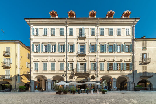 Cuneo, Italy - July 27, 2026: Elegant facade of historic Palazzo Lovera hotel . 18th-century building features traditional Italian architecture with cream-colored exterior, light blue window shutters,