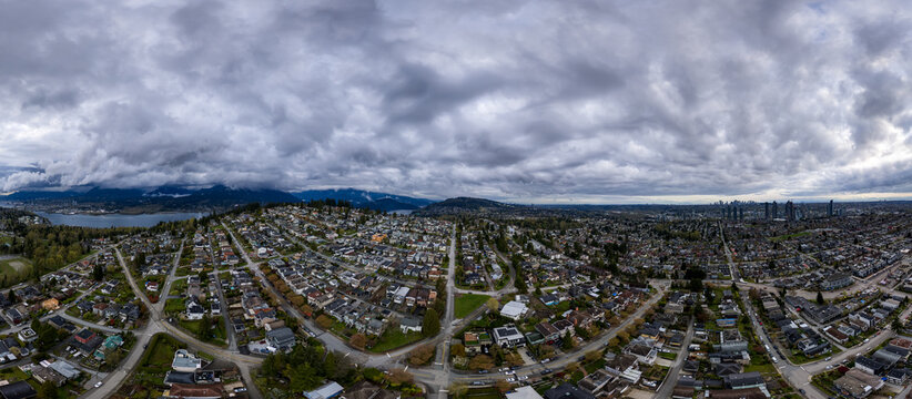 Aerial Panoramic View of Burnaby and Vancouver Skyline Under Dramatic Cloudy Skies