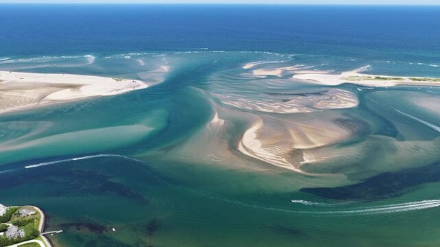 Currents from the Atlantic Ocean continuously shape the sand bars and scenic beaches of Cape Cod, Massachusetts. The entire peninsula is in constant movement due to its geologic makeup of mostly sand.