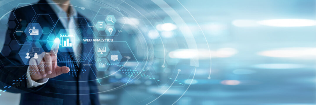 Digital marketer evaluating and touching Web Analytics traffic dashboards on a modern virtual screen. User engagement tracking, internet consumer behavior patterns, and site optimization.