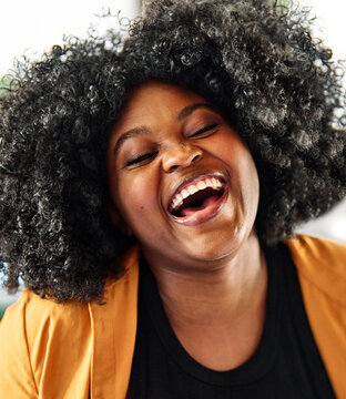 Portrait of a young happy black woman posing at home or in the office