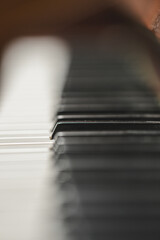 Dark abstract piano keys fading into soft musical shadows. © Trygve