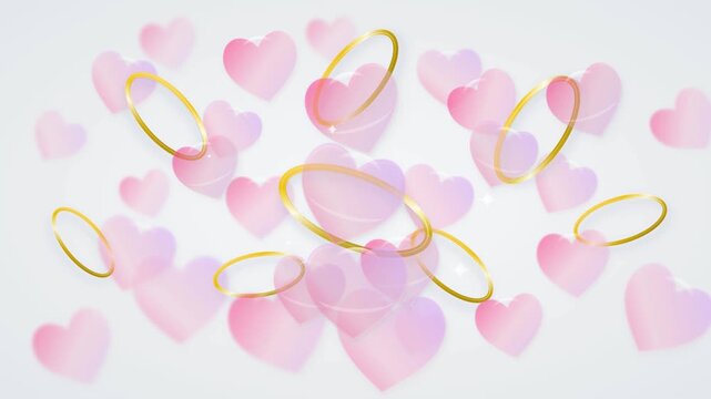 Elegant golden rings and pink heart bubbles floating on a romantic white background