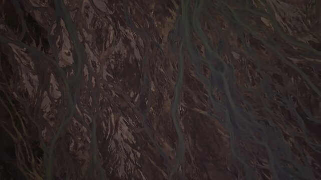 Cinematic aerial flight above braided glacial rivers in Iceland&rsquo;s remote Highlands revealing intricate river channels volcanic terrain and colorful landscapes near the Rainbow Mountains.