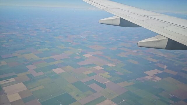 Airplane Wing Above Vast Patchwork Farmland in Argentina