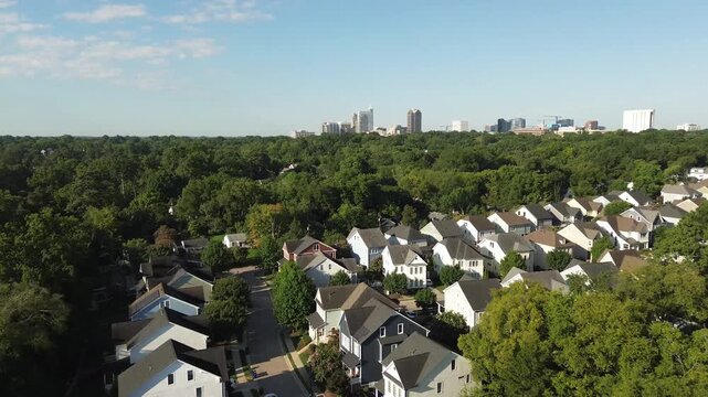 Aerial shot of new homes in the historic Oakdale and Mordecai neighborhood with downtown Raleigh NC skyline in the distance