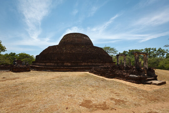 Scene featuring ancient Buddhist dagoba (stupe) Pabula Vihara. Ancient city of Polonnaruwa, Sri Lanka