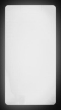 Vertical Vintage Film Frame with White Glow and Black Border. Empty Retro Frame with Subtle Grain and Soft Edges. Classic 16mm Look with Film Strip Texture and Light Vignette. Vertical Video