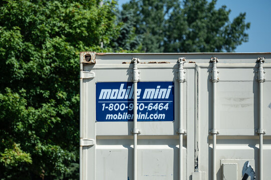 A Mobile Mini storage unit featuring their branded logo on a blue sign (Minnesota, USA - July 26, 2026). Editorial Use Only.