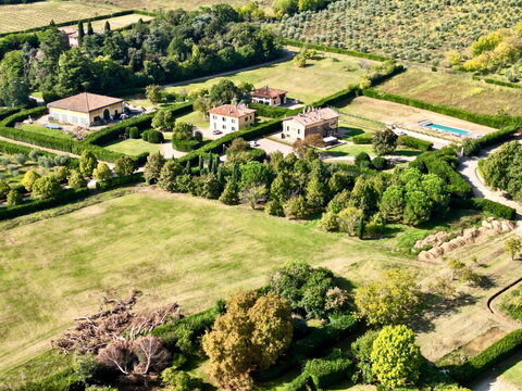 Drone view of countryside villa houses with pool in Italy for real estate background