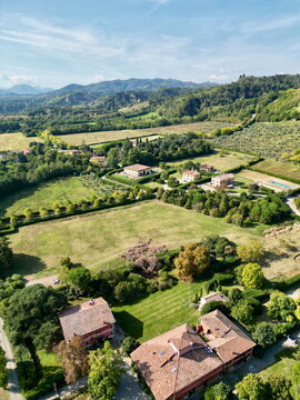 Vertical aerial view of countryside village and hills in Italy for poster background